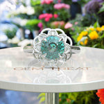 Load image into Gallery viewer, Garden of Glow: Floral Style Halo Ring with Dazzling Portuguese Cut Cyan Blue Moissanite in Silver
