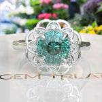 Load image into Gallery viewer, Garden of Glow: Floral Style Halo Ring with Dazzling Portuguese Cut Cyan Blue Moissanite in Silver
