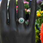 Load image into Gallery viewer, Garden of Glow: Floral Style Halo Ring with Dazzling Portuguese Cut Cyan Blue Moissanite in Silver
