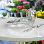 Load image into Gallery viewer, Harvest Glow: Pear-Shaped Yellow Moissanite Halo Engagement Ring in Timeless Silver Design
