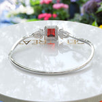 Load image into Gallery viewer, Crimson Elegance: 4.0ct Emerald Cut Garnet Bangle Bracelet Adorned with Marquise Moissanites
