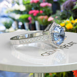 Load image into Gallery viewer, Elegance Defined: Round Blue Moissanite Centerpiece in Stunning Engagement Ring
