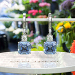 Load image into Gallery viewer, Sky’s Whisper: Blue Asscher Cut Moissanite Drop Earrings.
