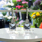 Load image into Gallery viewer, Sky’s Whisper: Blue Asscher Cut Moissanite Drop Earrings.
