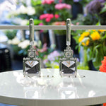 Load image into Gallery viewer, Elegant Echoes: Large 10.0ctw Asscher Cut Gray Moissanite Drop Earrings.
