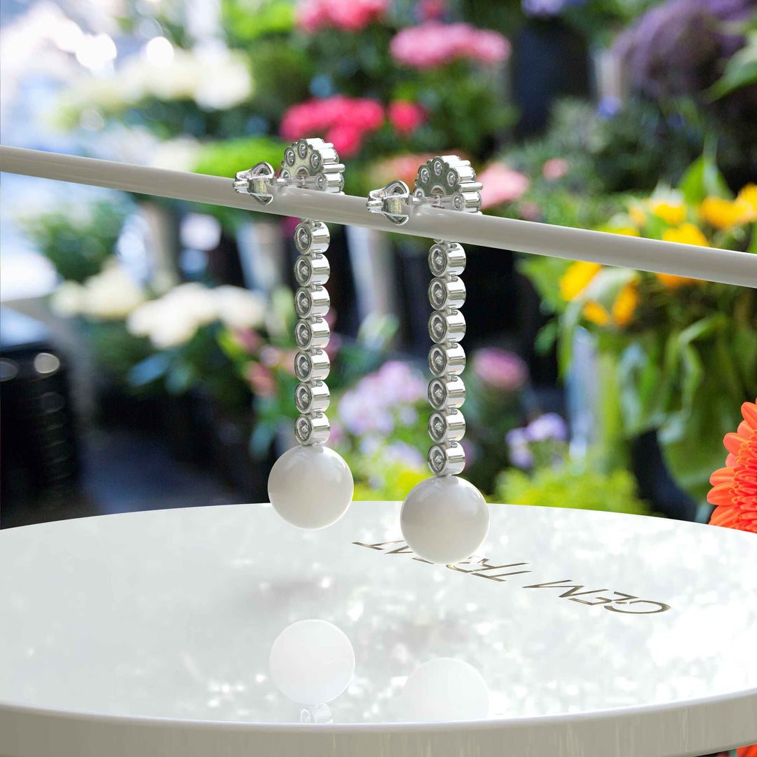 Classic Meets Sparkle: Pearl Drop Earrings with Moissanite Centerpiece.