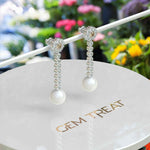 Load image into Gallery viewer, Classic Meets Sparkle: Pearl Drop Earrings with Moissanite Centerpiece.
