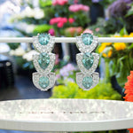 Load image into Gallery viewer, Enchanted Evening: Cyan Moissanite Hoop Earrings with Dazzling Halo
