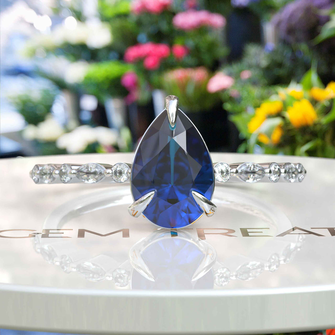 Deep Sea Elegance: Pear Cut London Blue Topaz Ring with Marquise Moissanite Accents in Silver