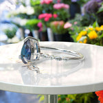 Load image into Gallery viewer, Deep Sea Elegance: Pear Cut London Blue Topaz Ring with Marquise Moissanite Accents in Silver
