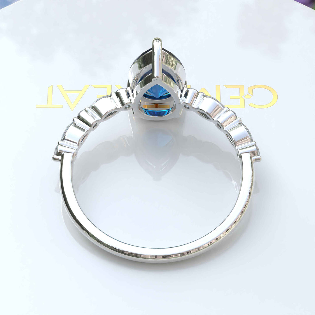 Deep Sea Elegance: Pear Cut London Blue Topaz Ring with Marquise Moissanite Accents in Silver