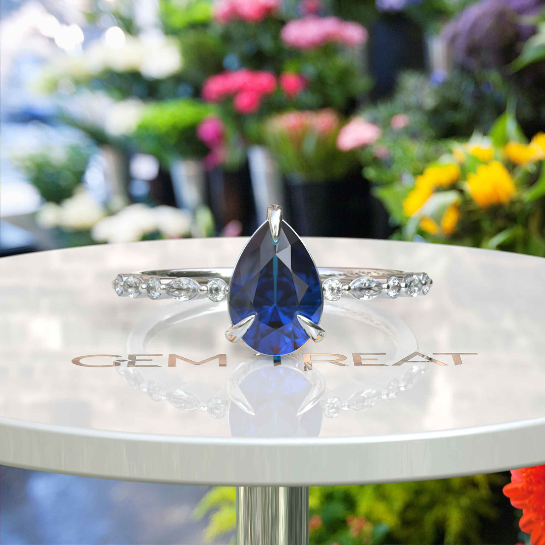 Deep Sea Elegance: Pear Cut London Blue Topaz Ring with Marquise Moissanite Accents in Silver