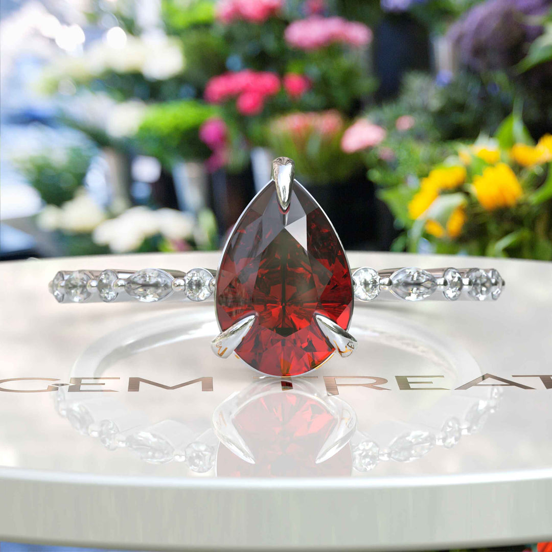 Gems of Desire and Dreams: Pear Cut Ruby Ring Elegance, Elevated by Marquise Moissanite Details