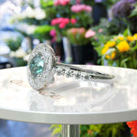 Load image into Gallery viewer, Aqua Elegance: Portuguese Cut Cyan Blue Moissanite Ring with Sparkling Halo Accent
