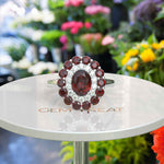 Load image into Gallery viewer, Whispers of Romance: Discover the Lustrous Oval Halo Garnet within This Ring Design
