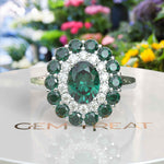 Load image into Gallery viewer, Emerald Oasis: Double Halo Oval Green Emerald Ring with Moissanite &amp; Emerald Embellishments.
