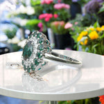 Load image into Gallery viewer, Emerald Oasis: Double Halo Oval Green Emerald Ring with Moissanite &amp; Emerald Embellishments.
