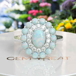 Load image into Gallery viewer, Ethereal Glow: Oval Opal Centerpiece Ring Surrounded by Moissanite and Opal Halo
