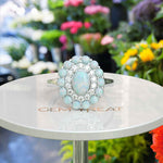 Load image into Gallery viewer, Ethereal Glow: Oval Opal Centerpiece Ring Surrounded by Moissanite and Opal Halo
