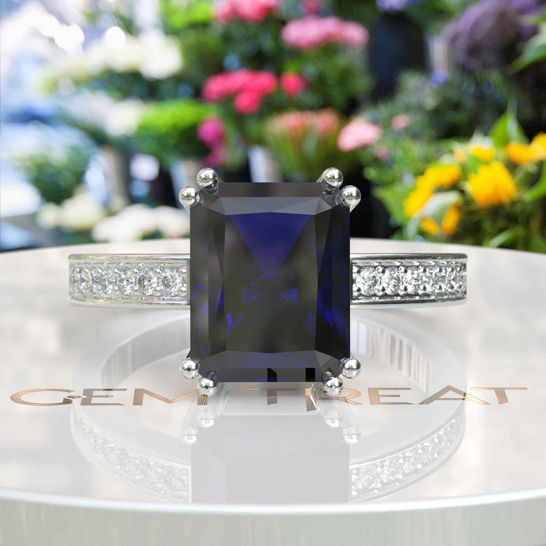 Celebrate Timeless Beauty: Adorned with 4.0ct Emerald Cut Blue Sapphire in Solitaire Setting