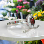 Load image into Gallery viewer, Moissanite Halo Surrounds a Brilliant Oval Red Garnet Ring
