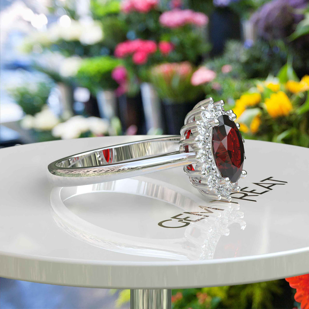 Moissanite Halo Surrounds a Brilliant Oval Red Garnet Ring