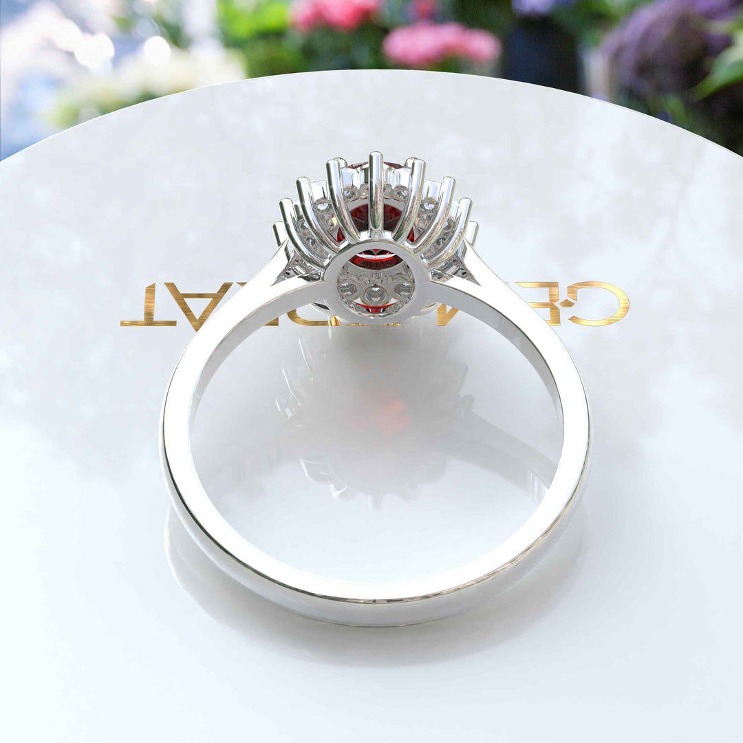 Moissanite Halo Surrounds a Brilliant Oval Red Garnet Ring