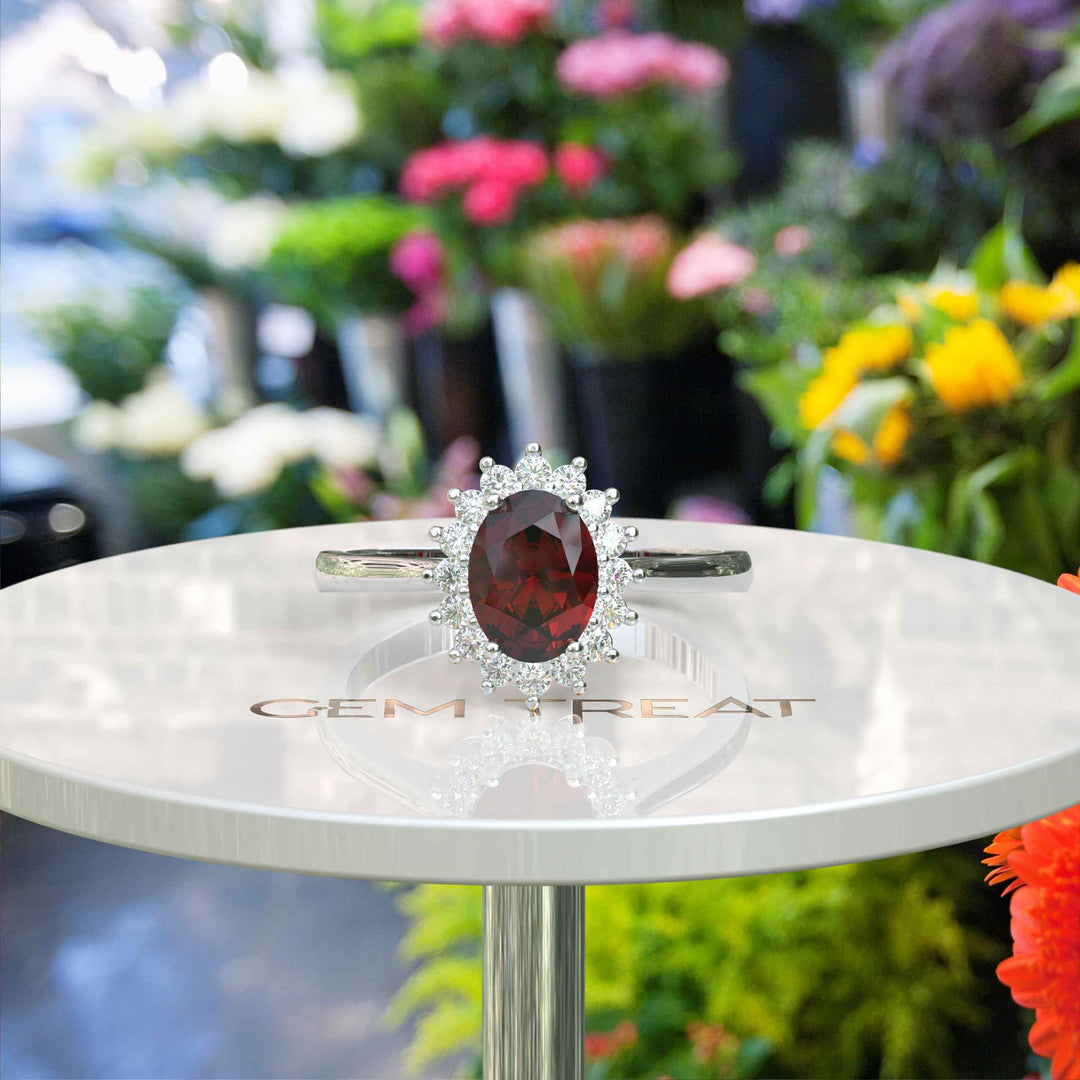 Moissanite Halo Surrounds a Brilliant Oval Red Garnet Ring