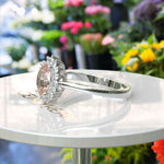 Load image into Gallery viewer, Blush Beauty: Oval Morganite Ring with Sparkling Moissanite Halo.
