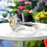 Load image into Gallery viewer, Blossoming Brilliance: Floral-Styled Round Yellow Sapphire Ring with Moissanite Halo.
