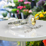 Load image into Gallery viewer, Blossoming Brilliance: Floral-Styled Round Yellow Sapphire Ring with Moissanite Halo.
