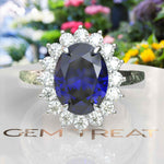 Load image into Gallery viewer, The Pinnacle of Romance: 4.0ct Oval Blue Sapphire Halo Ring Adorned with Moissanite Accents.
