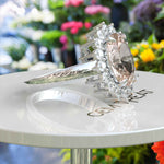 Load image into Gallery viewer, Elegant 4.0ct Oval Morganite Ring Surrounded by Glistening Moissanite Halo
