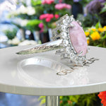 Load image into Gallery viewer, Ethereal Glow: 4.0ct Rose Quartz Oval Ring with Dazzling Moissanite Halo.
