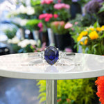 Load image into Gallery viewer, Twilight Dream: Stunning Oval Blue Sapphire Ring with Moissanite Companions.
