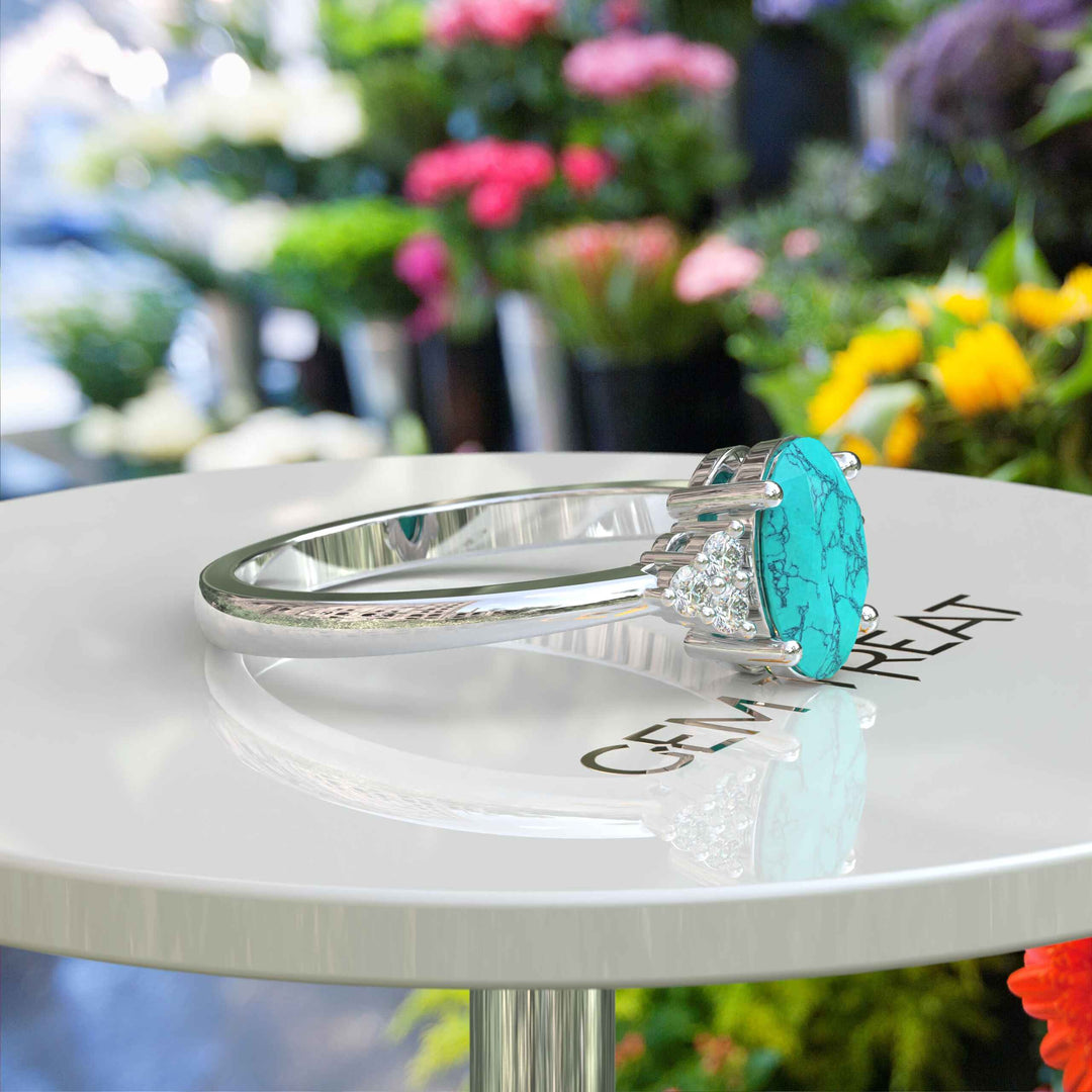 Mesmeric Blue: Oval Turquoise Ring with Brilliant Moissanite Companions.