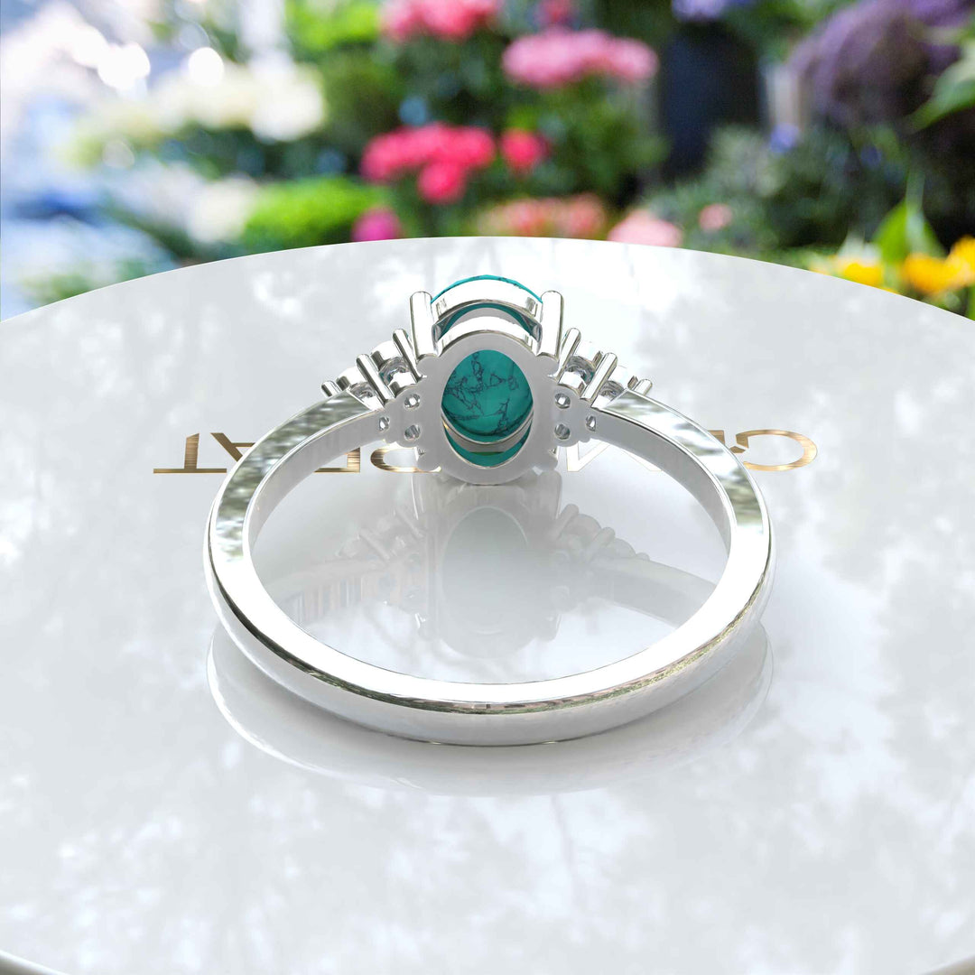 Mesmeric Blue: Oval Turquoise Ring with Brilliant Moissanite Companions.